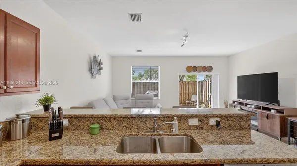 a kitchen with a faucet a sink and a window