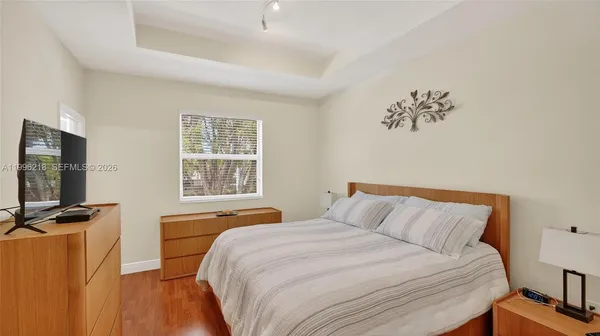 a bedroom with a bed and a flat screen tv