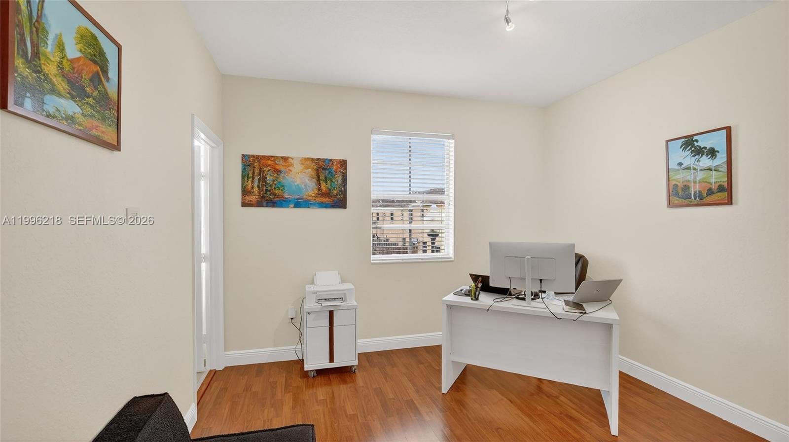 9041 Southwest 227th Street, Unit 5 Cutler Bay, FL 33190 - Photo 17 of 41 a workspace with furniture and wooden floor
