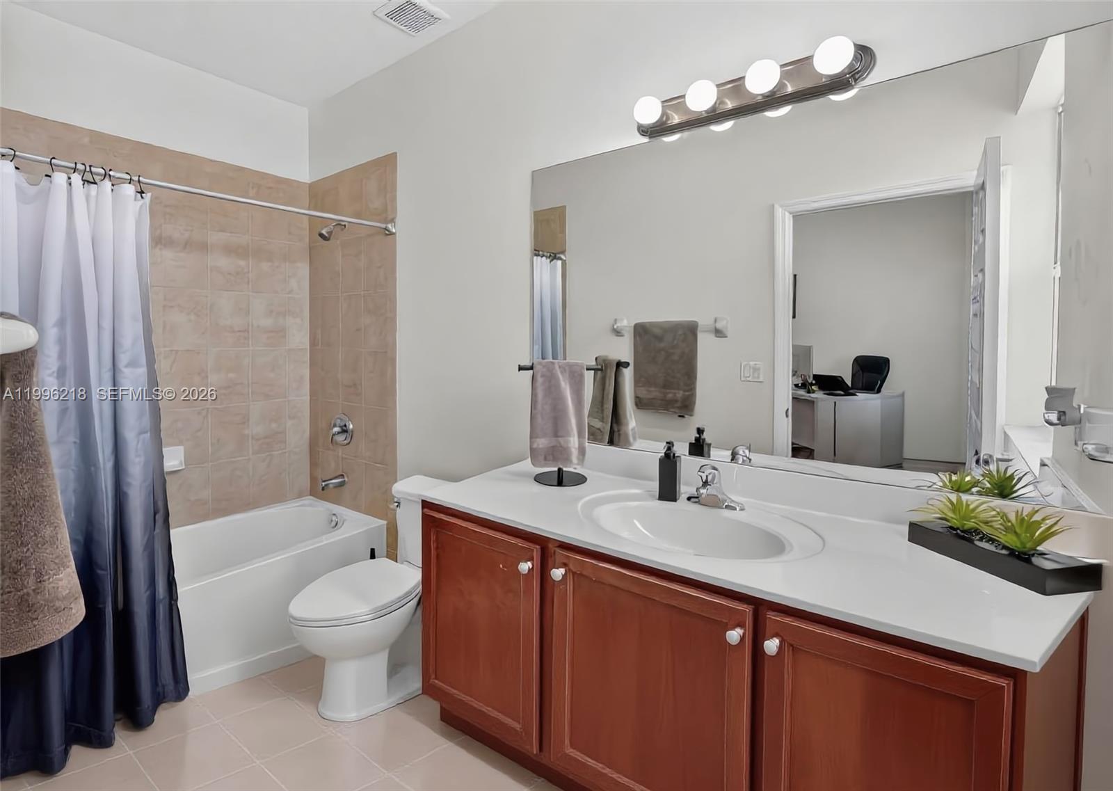 9041 Southwest 227th Street, Unit 5 Cutler Bay, FL 33190 - Photo 19 of 41 a bathroom with a sink a toilet and shower