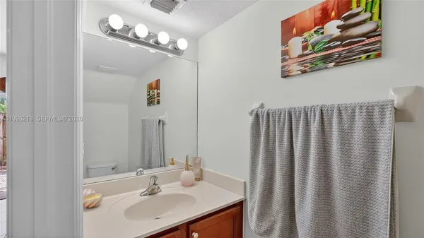 a bathroom with a sink a mirror and a shower curtain