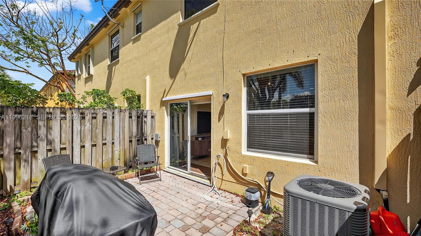 9041 Southwest 227th Street, Unit 5 Cutler Bay, FL 33190 - Photo 28 of 41 a view of balcony with two chairs and a barbeque