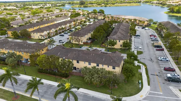 an aerial view of a house with outdoor space and lake view