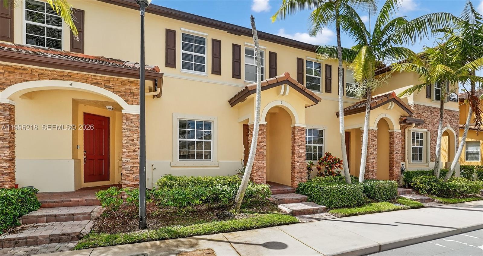 9041 Southwest 227th Street, Unit 5 Cutler Bay, FL 33190 - Photo 33 of 41 a front view of a multi story residential apartment building