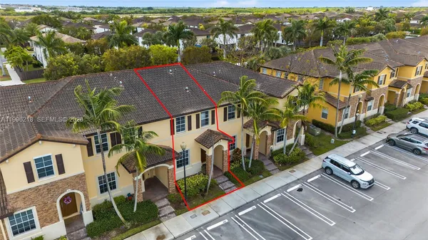 an aerial view of residential houses with outdoor space