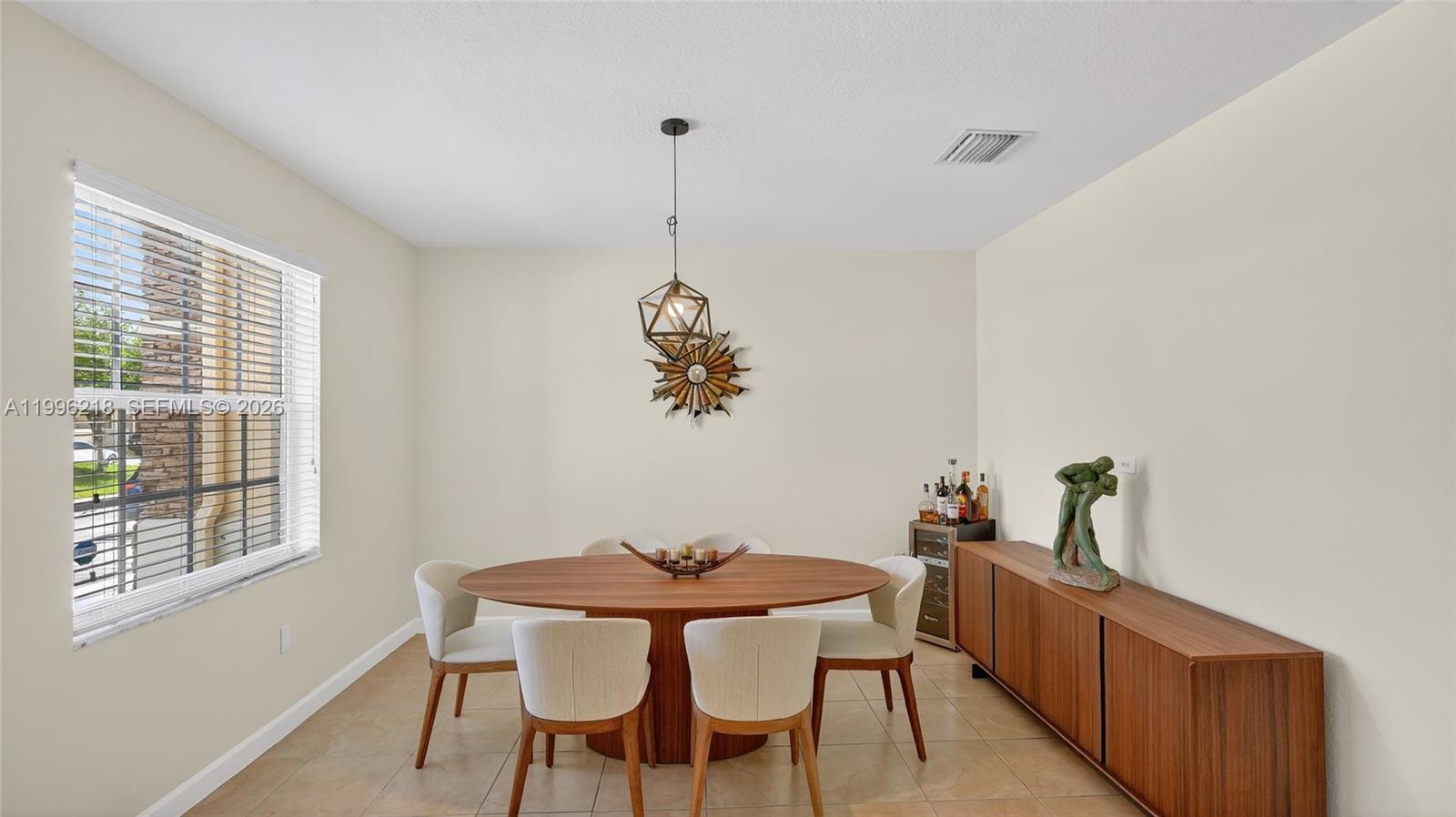 9041 Southwest 227th Street, Unit 5 Cutler Bay, FL 33190 - Photo 4 of 41 a view of a dining room with furniture window and outside view