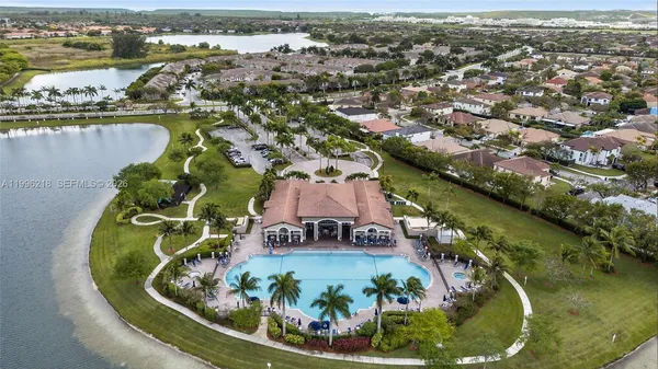 an aerial view of residential houses with outdoor space and lake view