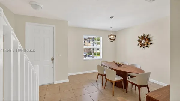 a dining room with furniture and window