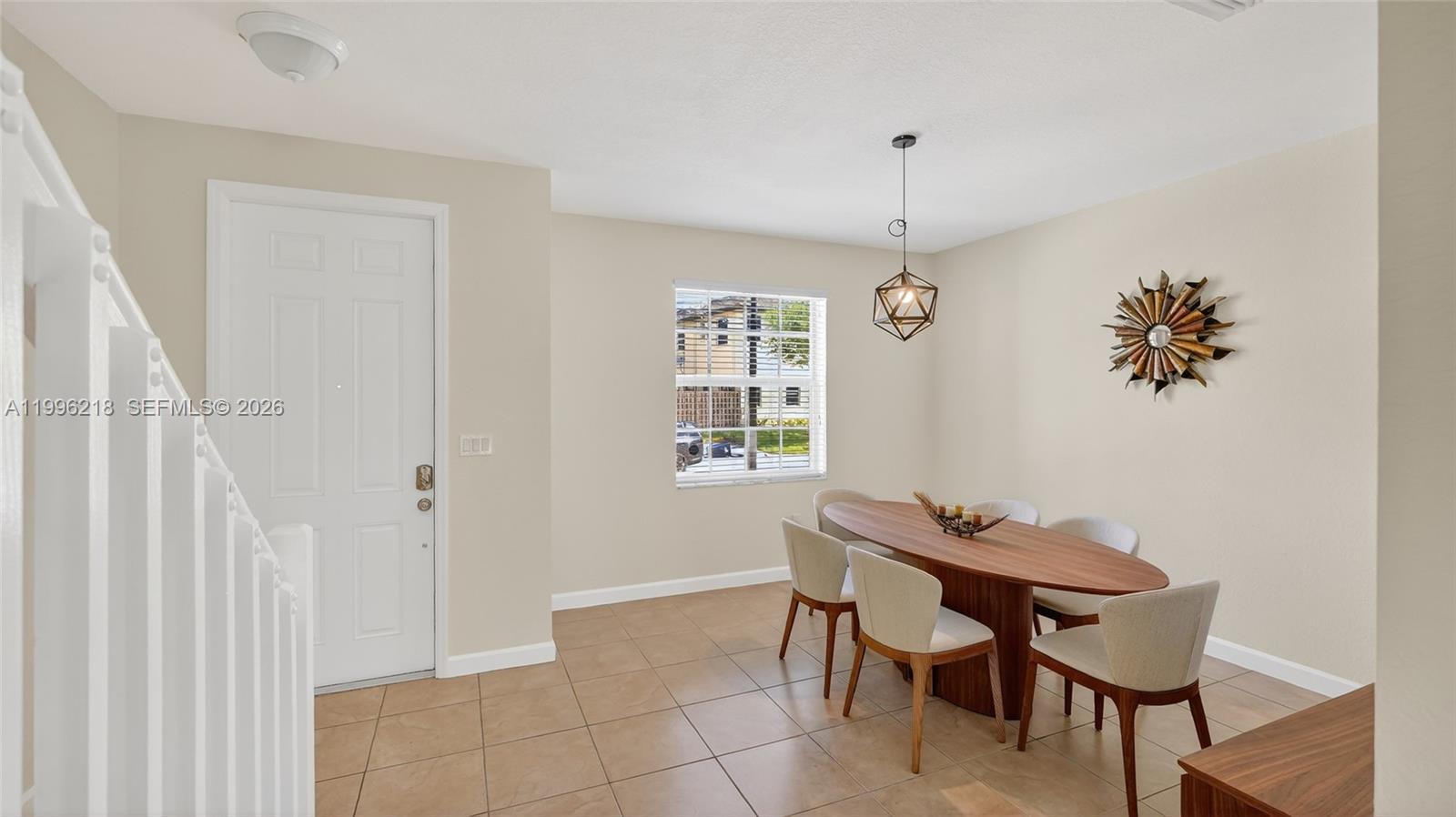 9041 Southwest 227th Street, Unit 5 Cutler Bay, FL 33190 - Photo 5 of 41 a dining room with furniture and window