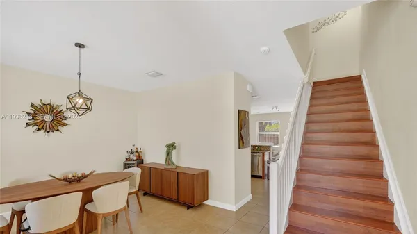 a view of a room with furniture and wooden floor