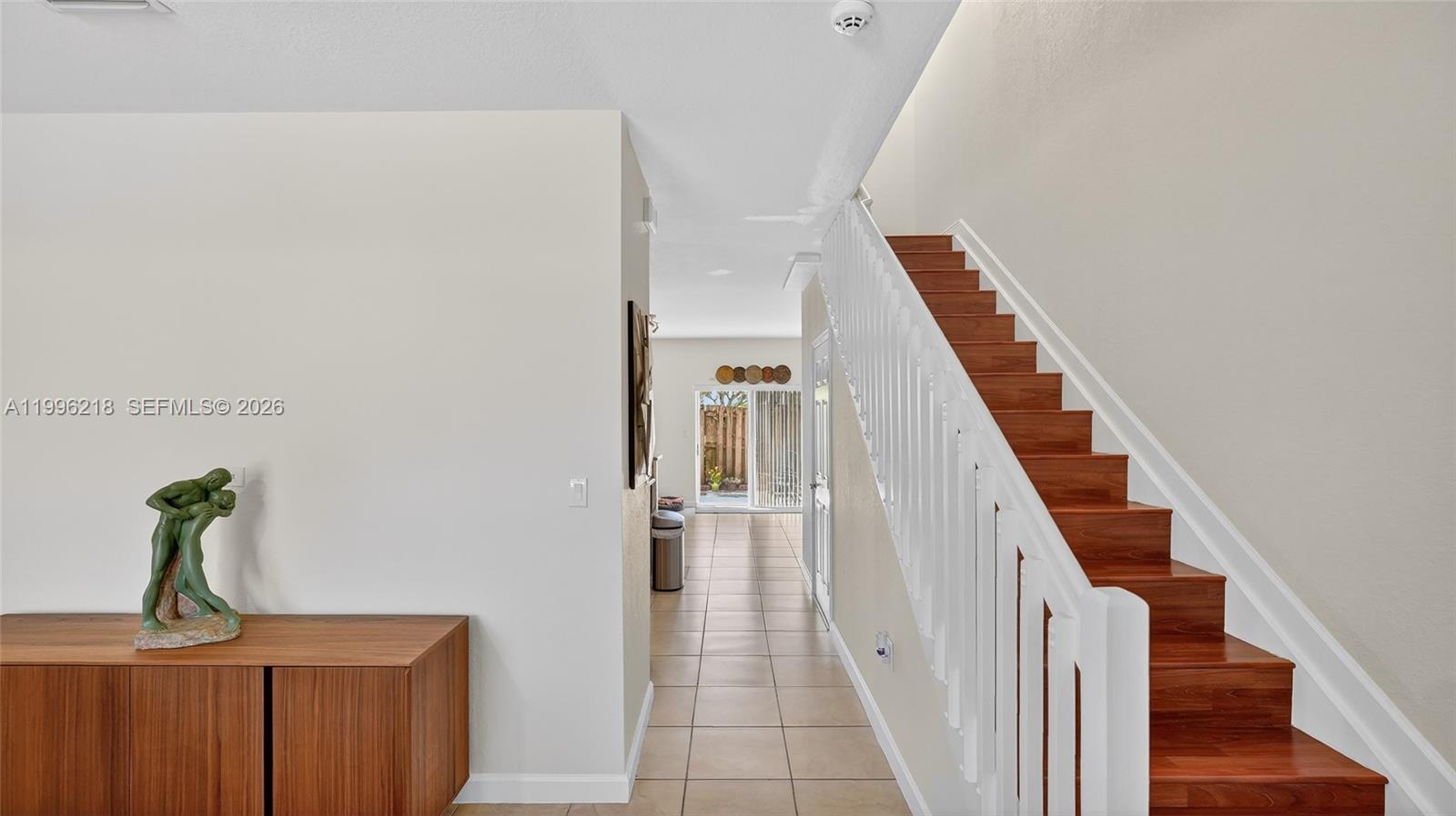 9041 Southwest 227th Street, Unit 5 Cutler Bay, FL 33190 - Photo 10 of 41 a view of a hallway with staircase