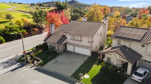 an aerial view of a house with a garden and trees