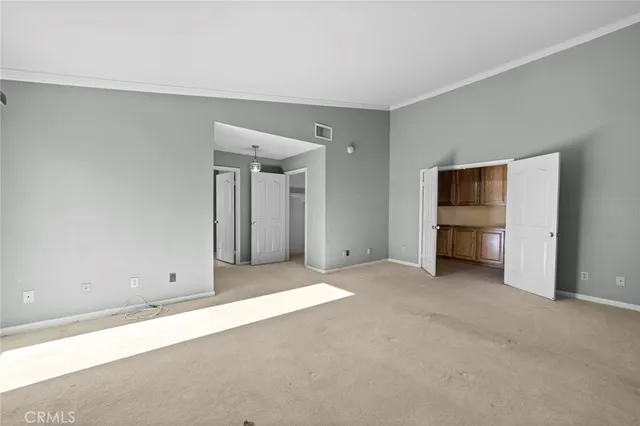 an empty room with an empty space and closet area