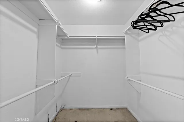 a view of walk in closet with clothes