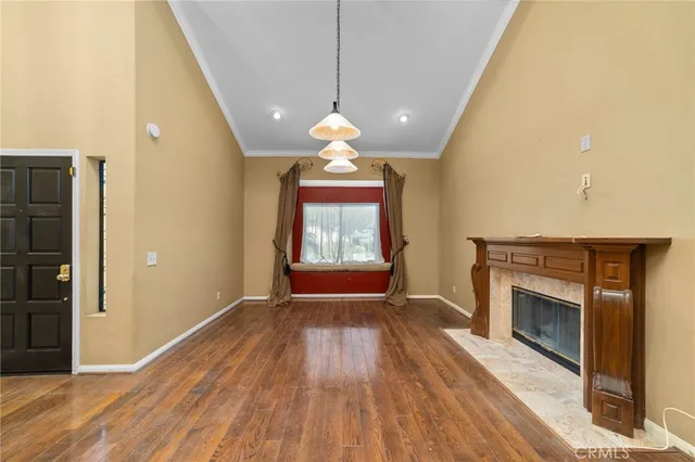 a living room with a fireplace and wooden floor