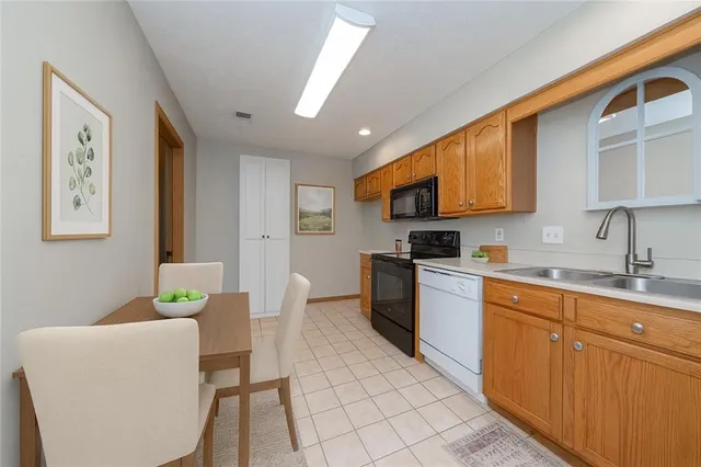 a kitchen with a sink cabinets and window