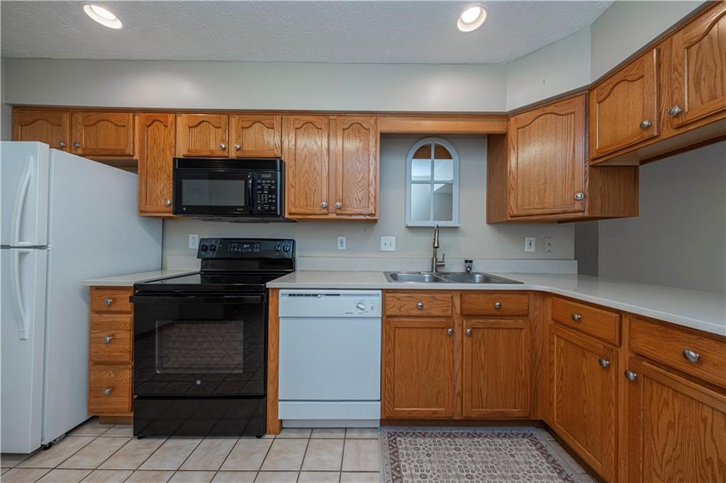 131 Pony Drive Freedom, PA 15042 - Photo 13 of 39 a kitchen with stainless steel appliances granite countertop a refrigerator and a stove top oven