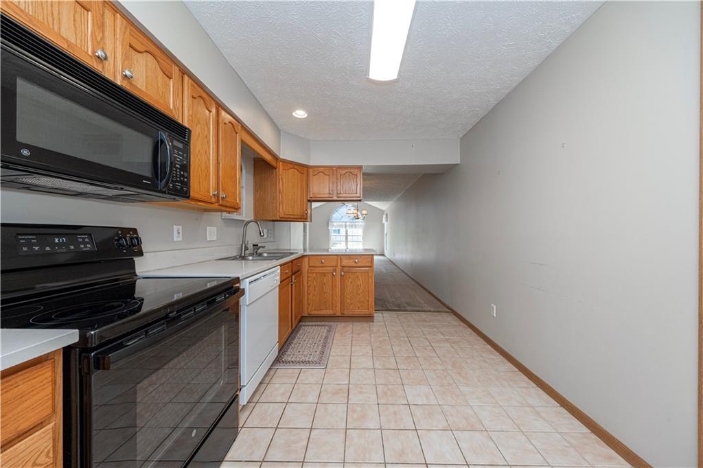131 Pony Drive Freedom, PA 15042 - Photo 15 of 39 a kitchen with stainless steel appliances a stove a microwave and sink