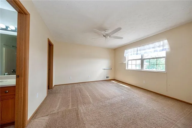 an empty room with a window and a hallway