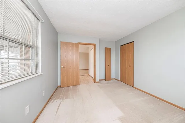 a bedroom with a bed a desk and chair