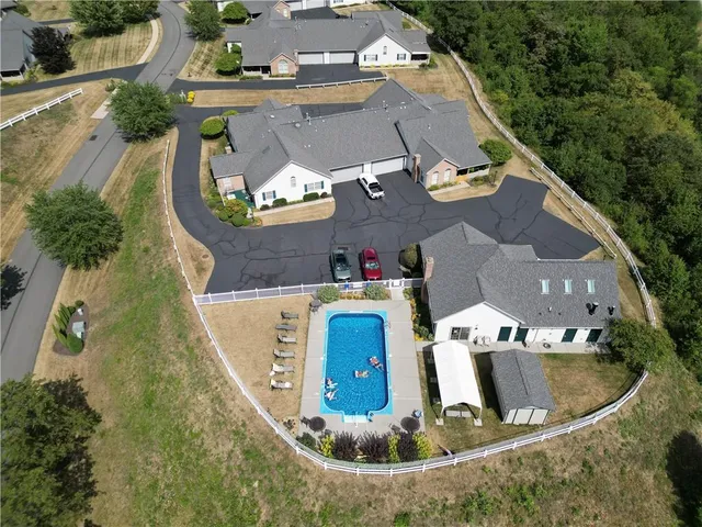 an aerial view of a house with outdoor space and lake view