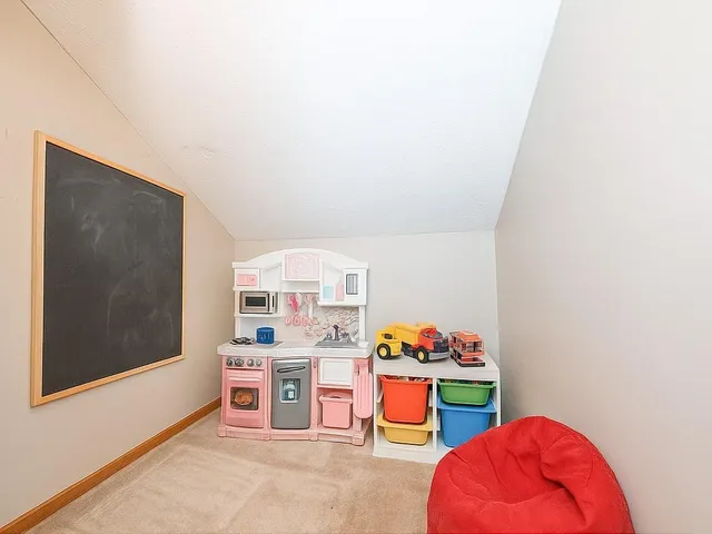 a kitchen with a refrigerator and a more potted plant