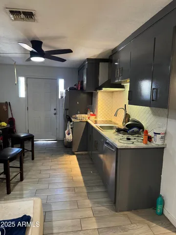 a kitchen with stainless steel appliances granite countertop a stove and a refrigerator