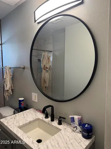 a bathroom with a sink and a mirror