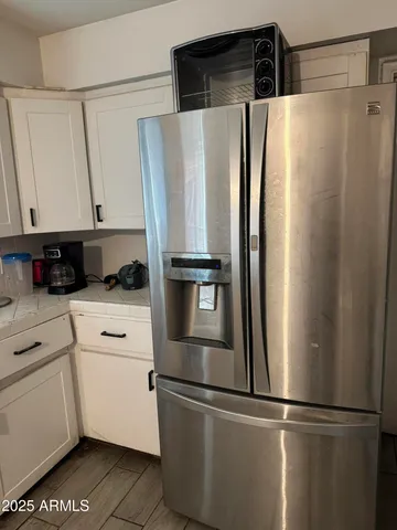 a white refrigerator freezer and a stove sitting inside of a kitchen