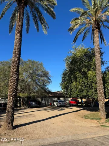 a view of a street with a building and trees in the background