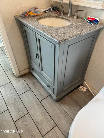a bathroom with a granite countertop sink and a mirror