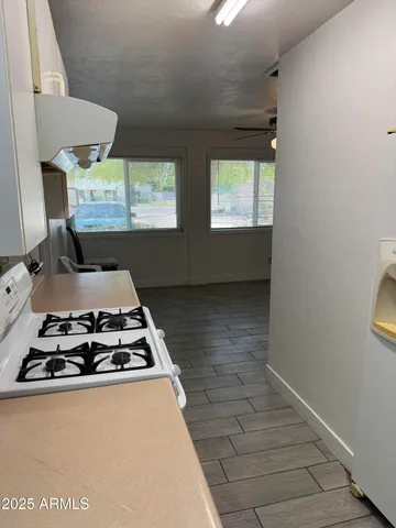 a kitchen with kitchen island a stove and a refrigerator