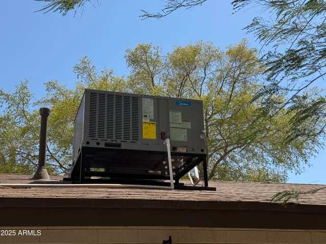 a view of a yard and car parked from a window
