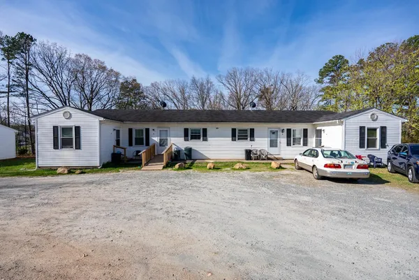 a view of house with swimming pool and yard