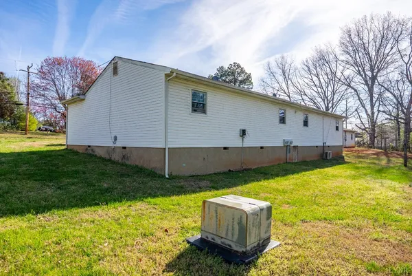 a view of a backyard with plants and a patio