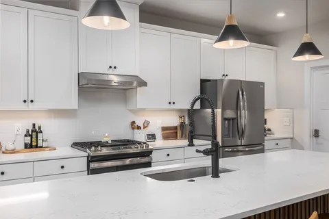 a view of a livingroom with furniture and a flat screen tv