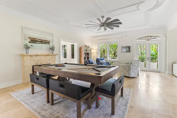 a kitchen with a refrigerator a sink dishwasher with a dining table and chairs