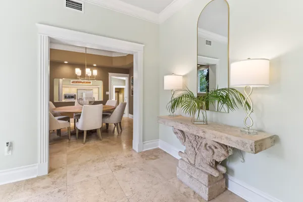 a dining room with furniture a chandelier and window