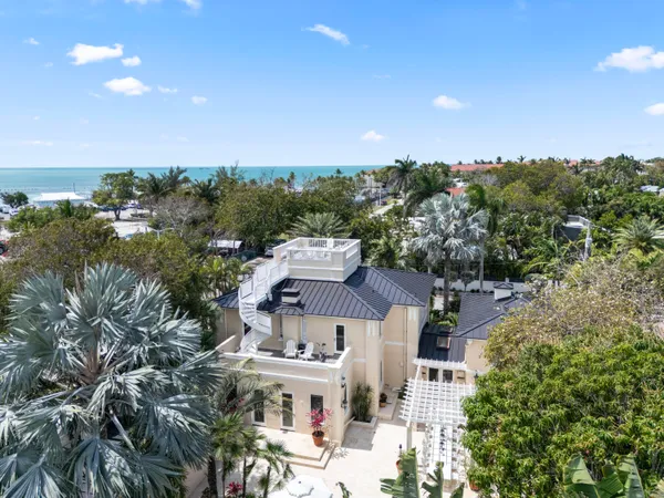 an aerial view of a house with a yard and garden