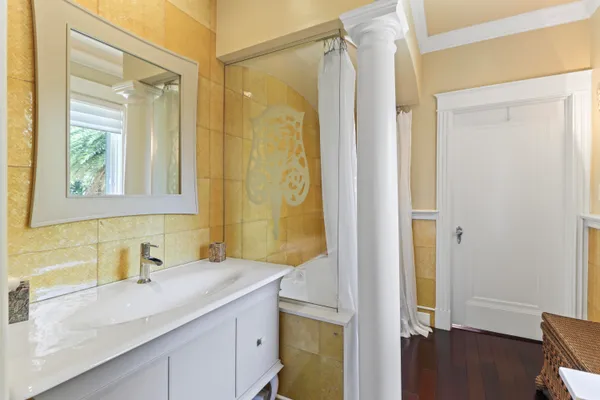 a view of a patio with a dining table and chairs under an umbrella with potted plants