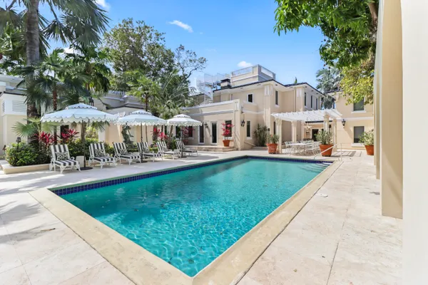 swimming pool view with a seating space and a garden