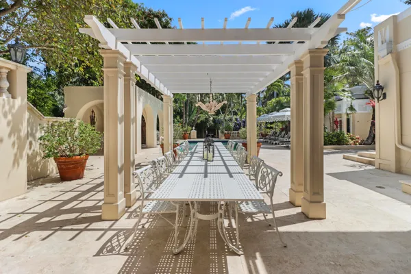 a front view of a house with a yard and potted plants