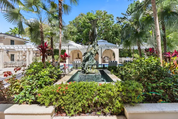a living room with furniture a flat screen tv and kitchen view