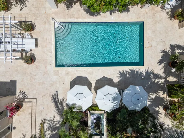 an aerial view of a house with garden space and street view