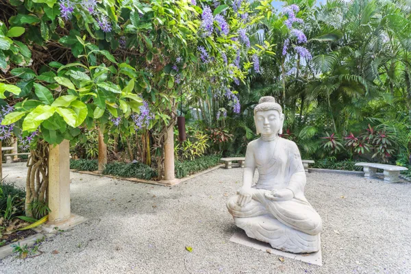 a backyard of a house with table and chairs potted plants