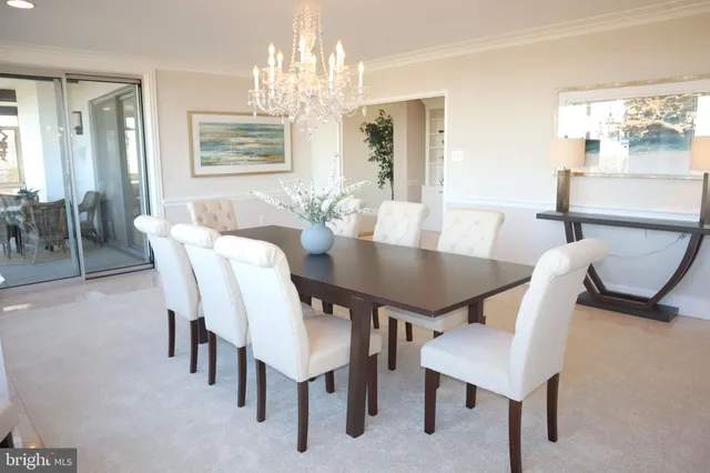 a view of a dining room with furniture and chandelier