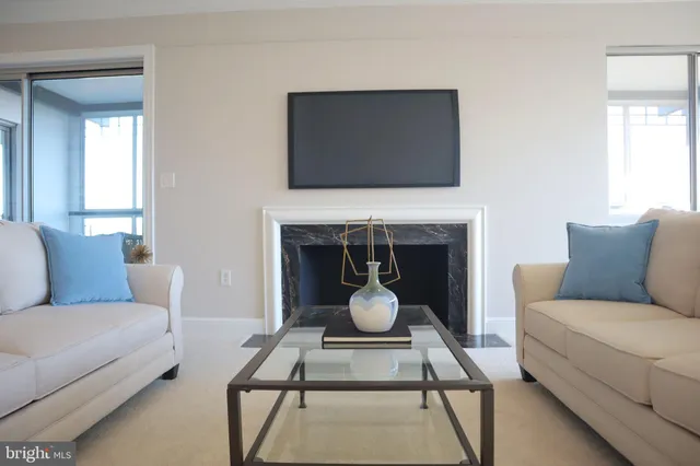 a view of a dining room with furniture and a chandelier