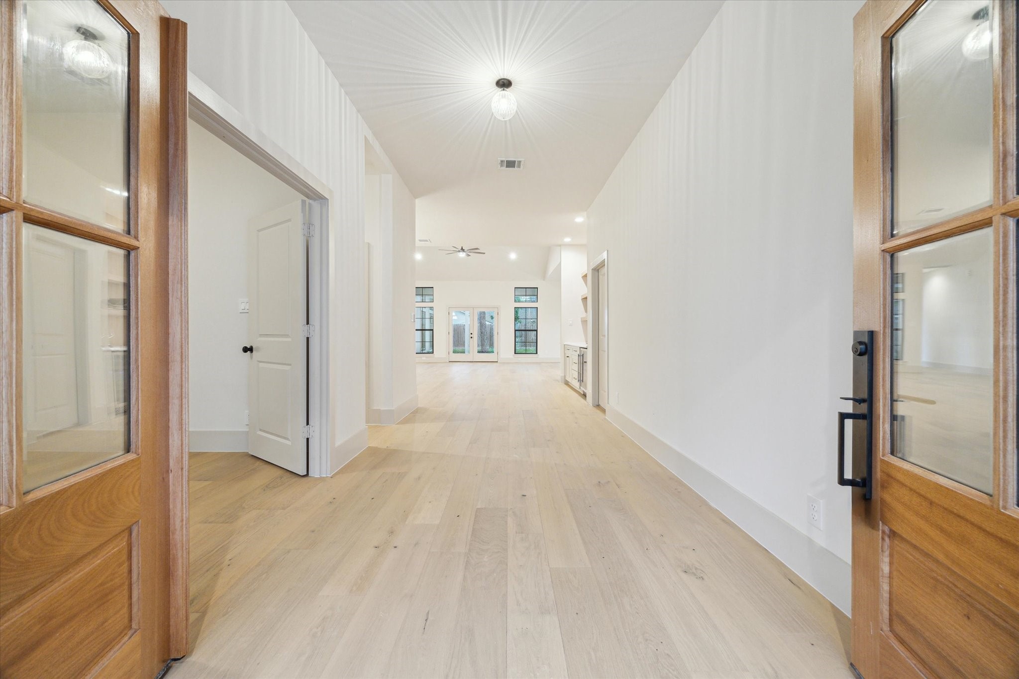 10303 Eddystone Drive Houston, TX 77043 - Photo 5 of 21 a view of a hallway with wooden floor