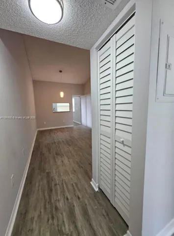 a view of wooden floor and windows in a room