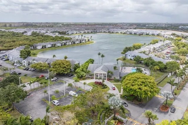 an aerial view of residential houses with outdoor space and seating